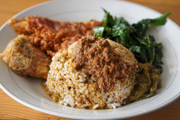 Nasi Padang with Minang-Style Omelette, Indonesia, captured on June 22, 2025. Traditional rice dish served with thick spiced omelette, curry sauce, vegetables, and sambal for a rich and hearty flavor.