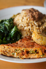Nasi Padang with Minang-Style Omelette, Indonesia, captured on June 22, 2025. Traditional rice dish served with thick spiced omelette, curry sauce, vegetables, and sambal for a rich and hearty flavor.