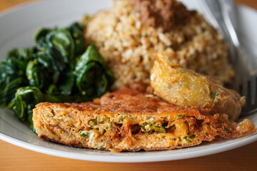 Nasi Padang with Minang-Style Omelette, Indonesia, captured on June 22, 2025. Traditional rice dish served with thick spiced omelette, curry sauce, vegetables, and sambal for a rich and hearty flavor.