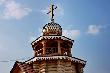 The wooden church is decorated with a carved dome topped with a cross.