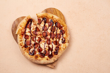 Delicious sausage pizza with a generous layer of cheese and juicy barbecue sauce, perfect for any celebration