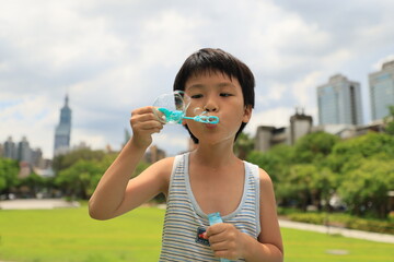 Boy blowing bubbles.