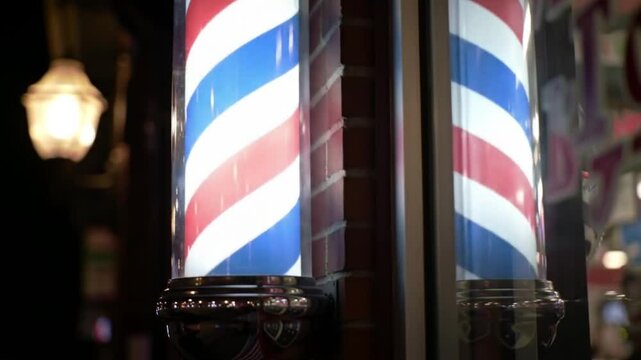 Two classic red white and blue barber poles. Suitable for barber shops, hair salons, vintage themes, patriotic designs, and Americana concepts.