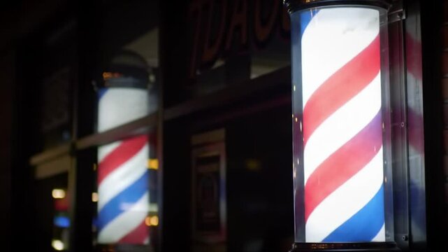 Two classic red white and blue barber poles. Suitable for barber shops, hair salons, vintage themes, patriotic designs, and Americana concepts.