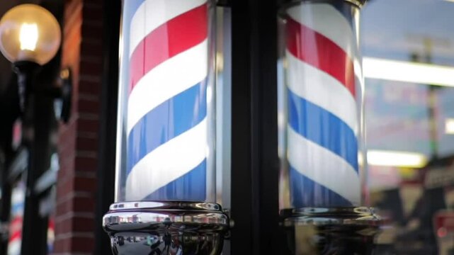 Two classic red white and blue barber poles. Suitable for barber shops, hair salons, vintage themes, patriotic designs, and Americana concepts.