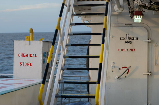 A ladder from the main deck to bridge deck on the offshore support vessel. It leads through the chemical store and the compressor room