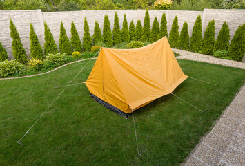 Old retro orange tent from 70s in the house garden