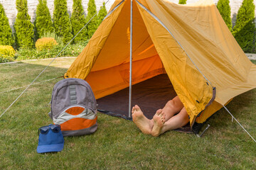 Old retro orange tent from 70s in the house garden