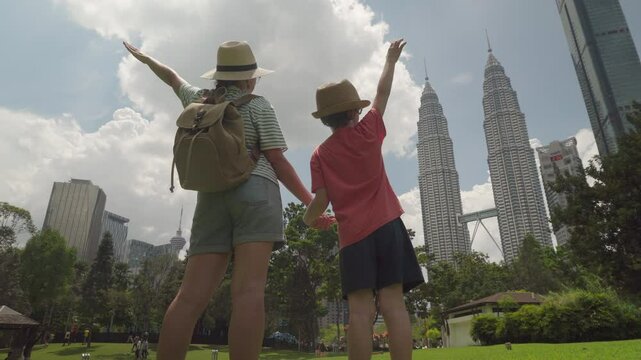 Female tourist and her son are raising their arms, Kuala Lumpur