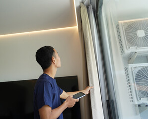 Worker with tablet computer checking air condition system