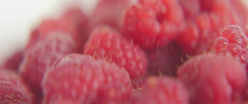 Taking one raspberry from plate 4k sliding scope video