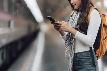Woman Using Smartphone at Train Station