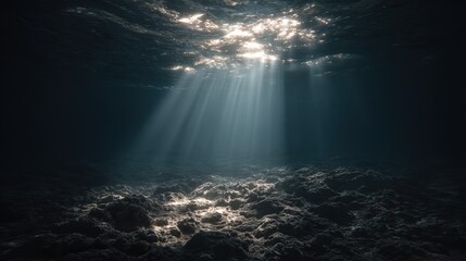 Sunlight beams penetrate the dark underwater scene, illuminating the rocky ocean floor with a mystical, serene ambiance