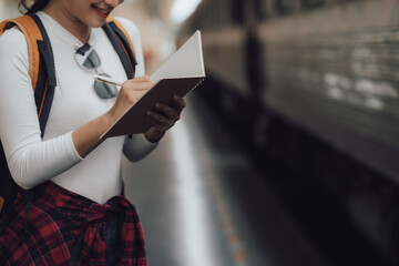 Woman Journaling at Train Station