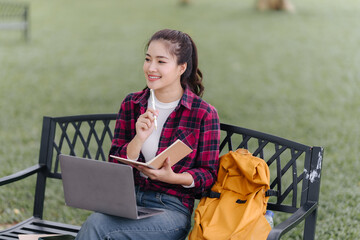 Smiling Student Studying Outdoors on Bench
