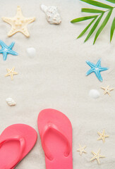 Pink flip flops, seashells, and starfishes creating relaxing summer beach background