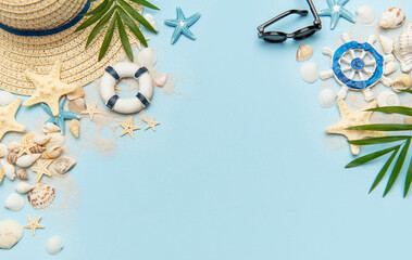 Summer vacation accessories creating a frame on blue background