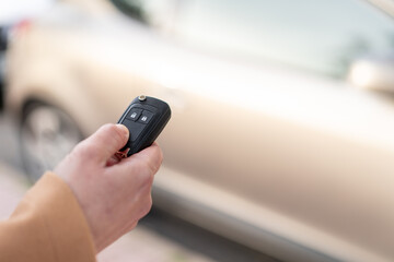 Young blonde woman holding car keys at outdoors