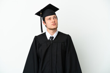 Young university Russian graduate isolated on white background and looking up