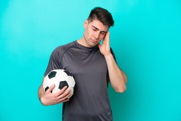 Young caucasian football player man isolated on blue background with headache