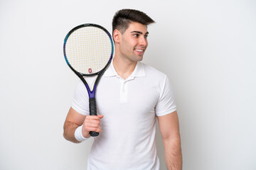 young tennis player man isolated on white background looking side
