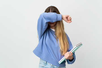 Young blonde student woman isolated on white background covering eyes by hands