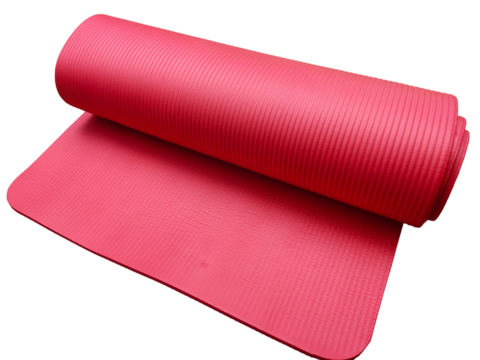 A textured pink yoga mat partially unrolled on a flat surface.