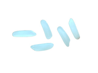 Five grains of white rice scattered randomly, each elongated and smooth with a slightly translucent...