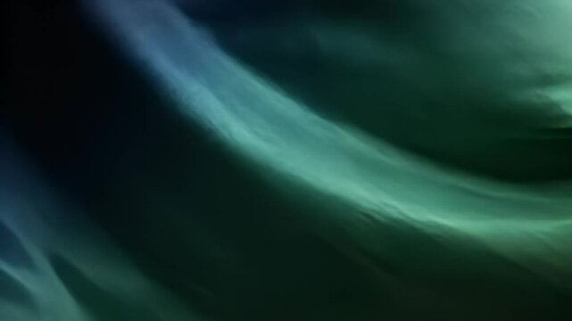 Abstract swathes of teal and black create flowing, blurred texture