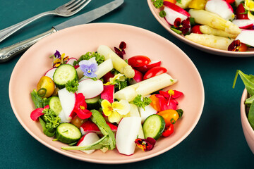 Fresh mixed salad with edible flowers.