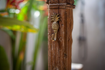 Metal Pineapple Hook Mounted on Carved Wooden Beam