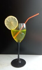 isolated cosmopolitan on a black background garnished with a lemon