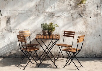 Sun-dappled patio set of wooden chairs and table against a weathered white wall, potted herbs adding a touch of nature