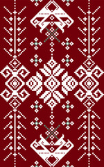 Traditional embroidery pattern featuring symmetrical geometric shapes and stylized birds in white and green on a deep red background.