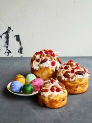 Traditional Easter celebration cakes decorated with colorful painted eggs festive holiday baking sweet bread desserts topped with almonds cranberries spring treats