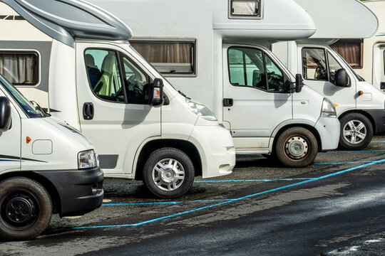 campers and motorhomes on asphatl parning, white auto caravan for  vacation travel