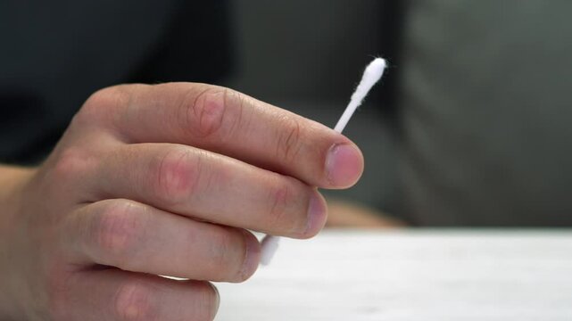 Ear stick in hands.
Cotton swab close-up.
Hygiene of auricles and dirt and microbes.
Ear, stick, white, sponge, ear stick