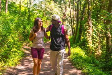 Hikers walking and talking on a trail in the woods