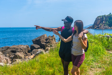 Tourists hiking along coast enjoying scenic view