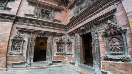 Fototapeta premium Intricate Wooden Carvings on Heritage Brick Structure in Bhaktapur Durbar Square, Nepal