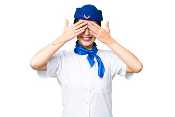 Airplane stewardess over isolated chroma key background covering eyes by hands