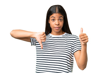 Young African american woman over isolated background making good-bad sign. Undecided between yes...