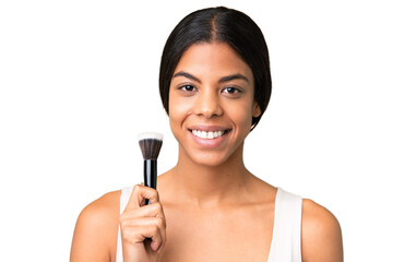 Young woman over over isolated chroma key background holding makeup brush and whit happy expression