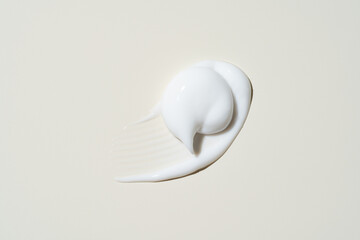Buttery skincare texture mid-stroke, showcasing effortless blendability and hydration for beauty...