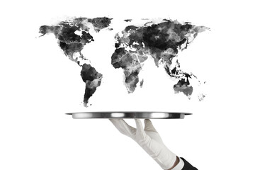 Gloved hand holding tray with black watercolor world map above, isolated on white background....