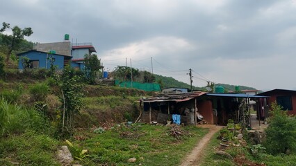 Rustic Huts Amidst Mountain Scenery: A Glimpse of Rural Village Life in Nature