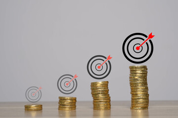 A visual representation of growth in finances, featuring stacked coins and target symbols...