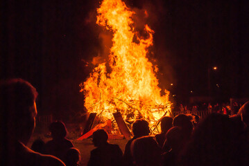 Silhouettes of people at a St. John's bonfire