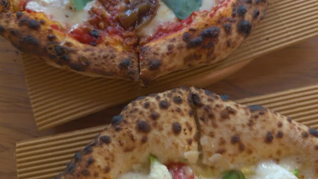 Delicious pizza variations topped with savory meat, creamy cheese, cherry tomatoes, zucchini, and fresh basil, served in a cozy local eatery.