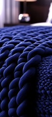 Obraz premium Cozy and Textured Navy Blue Knitted Blanket Close-Up Detail